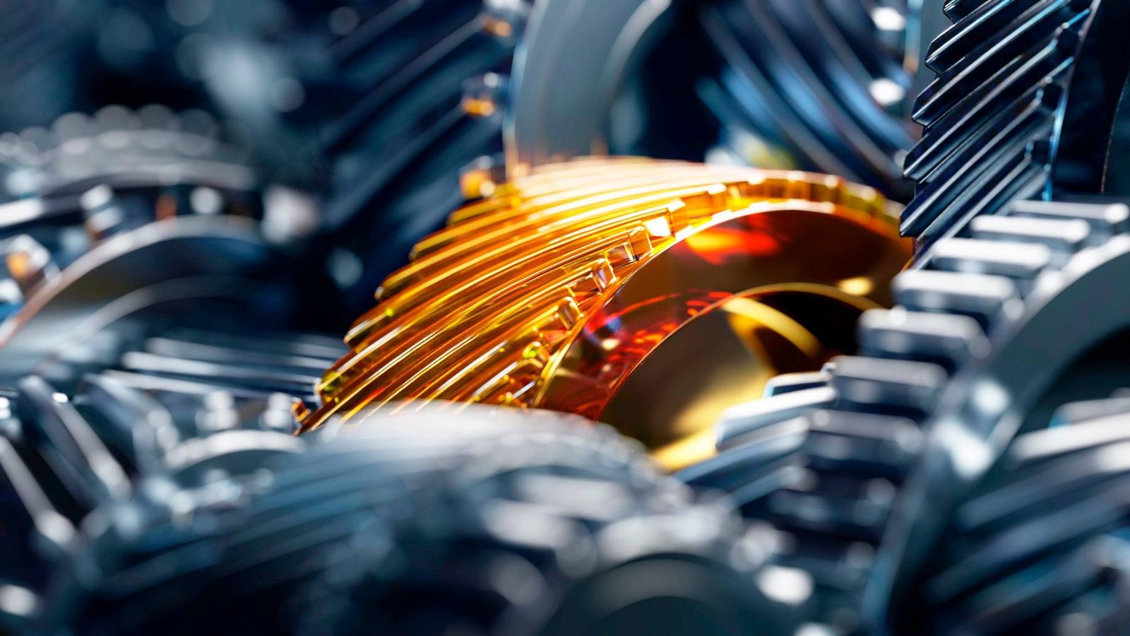Close-up of gears coated in amber lubricant